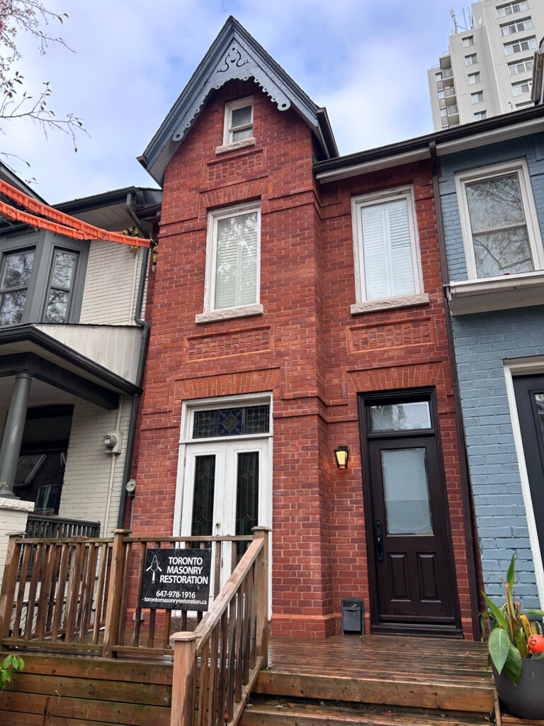 Victorian brick facade restoration project in Toronto showing rebuilt heritage brickwork.